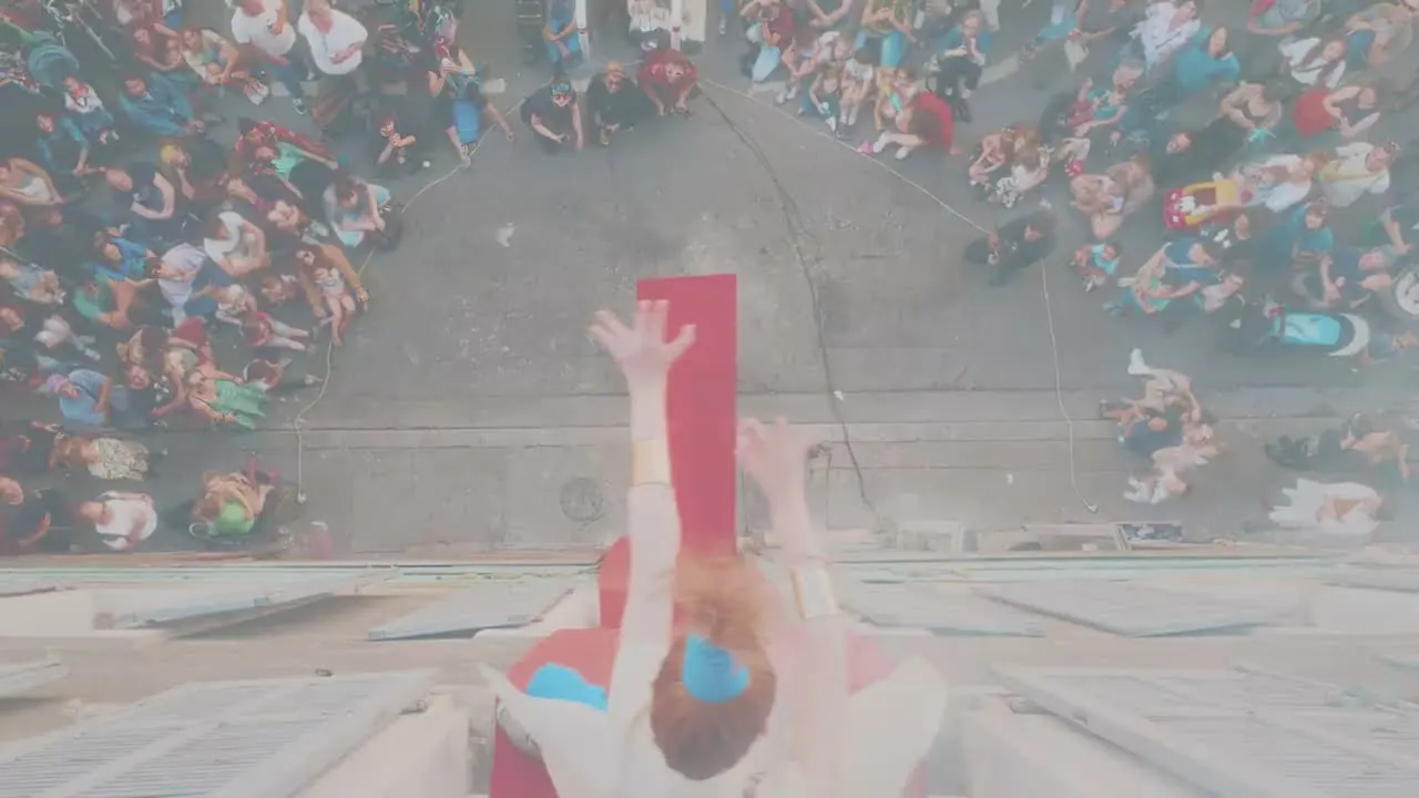 Looking down a façade at a dancer above the crowd, from the film Vertical Runway